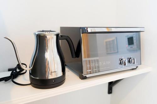 a coffee maker and a microwave on a shelf at MIYABI Highland Terrace Villa A in Fujiyoshida