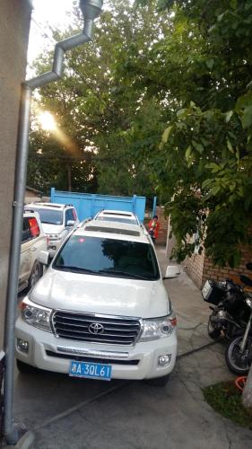 a white car parked in a parking lot at RAHAT Guest House & Hostel in Toktogul in Toktogul