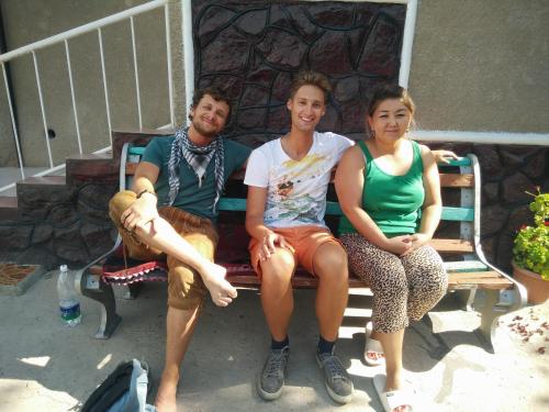 a group of three people sitting on a bench at RAHAT Guest House & Hostel in Toktogul in Toktogul