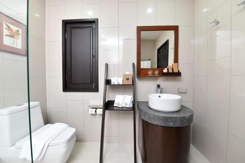 a bathroom with a sink and a toilet at El Barrio Lanna in Chiang Mai