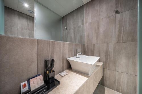 a bathroom with a sink and a mirror at Stay Month Hotel in Goyang