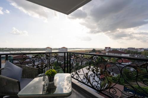 a balcony with a table and a view of the city at SureStay Hotel by Best Western Vientiane in Vientiane