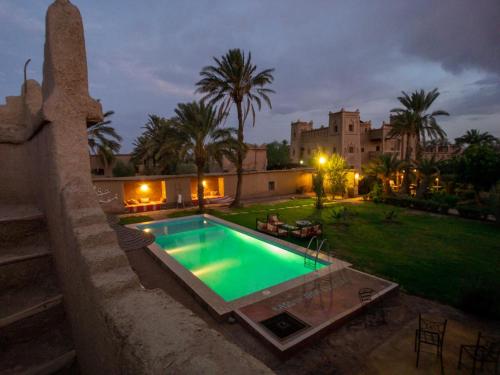 a swimming pool in the yard of a house at Dar Es Salam in Skoura