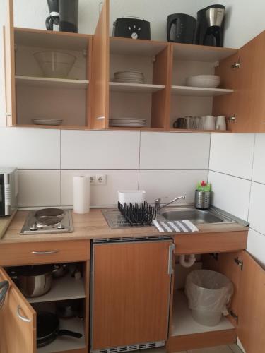 a kitchen with a sink and a counter top at Workers-Sleep-Station in Cologne