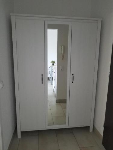 a large white door with a mirror in a room at Workers-Sleep-Station in Cologne