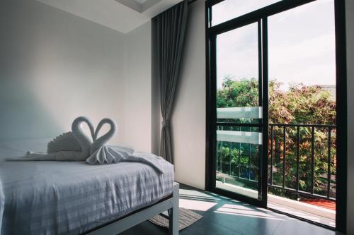 a bedroom with a bed and a large window at Good Place in Koh Tao