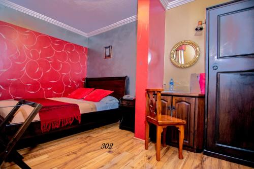 a bedroom with a bed and a table and a mirror at Morenica del Rosario in Cuenca
