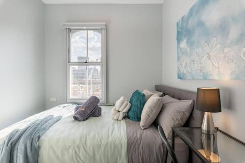 a white bedroom with a bed with a window at Luxe Ensuite Double Room - AC - Next to Central&CBD - Near Darling Harbour& Chinatown& USYD& UTS in Sydney