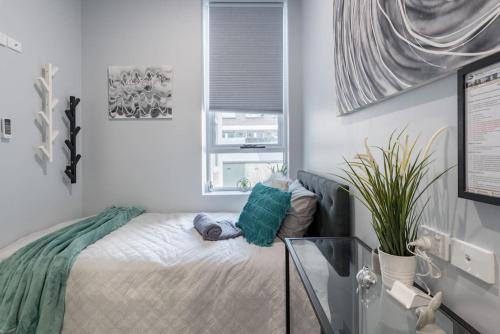 a small bedroom with a bed and a window at Ensuite King Single Room - AC - Next to Central - Closely Located to Almost Sydney Must Seen Spots in Sydney