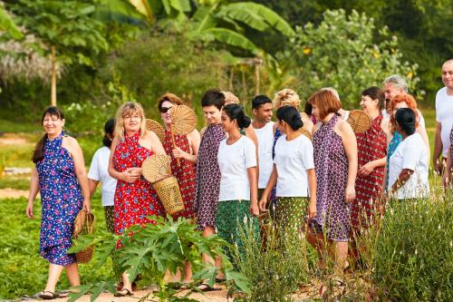 a group of people standing in a field at Amuna Ayurveda and Wellness Retreat in Sigiriya