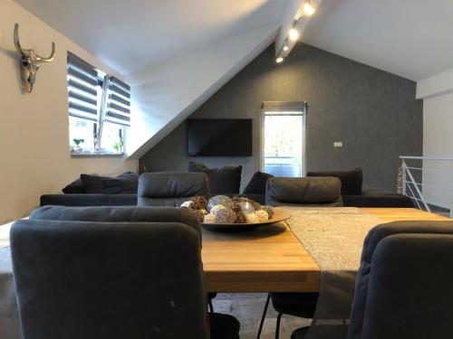 a living room with a table and a couch at Ermmes Ferienwohnungen in Sinsheim