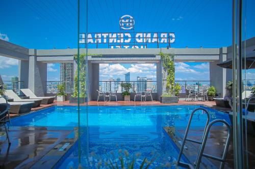 a swimming pool in a building with a view at HM Grand Central Hotel in Phnom Penh