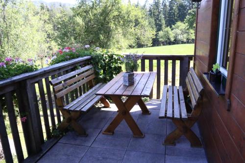 a wooden bench sitting on a porch next to a window at Ferienhaus am Mühlbach in Gams bei Hieflau