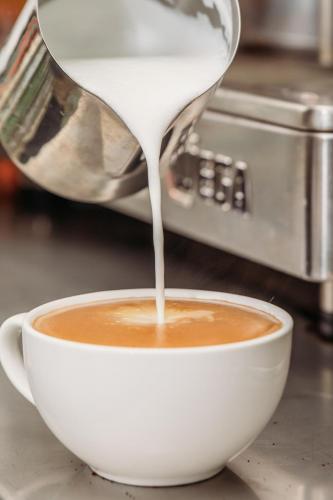 a coffee being poured into a cup of coffee at Kobbers Motor Inn in Dalby
