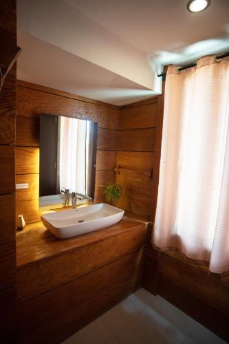 a bathroom with a sink and a mirror at La Estancia Busuanga in Busuanga