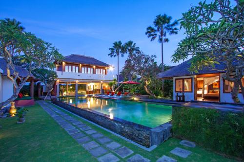 an exterior view of a villa with a swimming pool at Imani Villas in Canggu