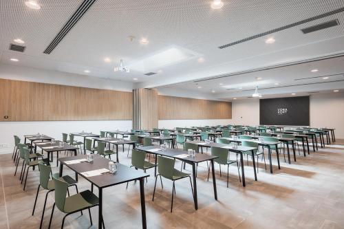 a large room with tables and chairs and a chalkboard at Acta Voraport in Barcelona