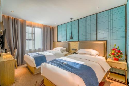 Postel nebo postele na pokoji v ubytování Echarm Hotel - Xiamen Zhongshan Road Pedestrian Street Branch