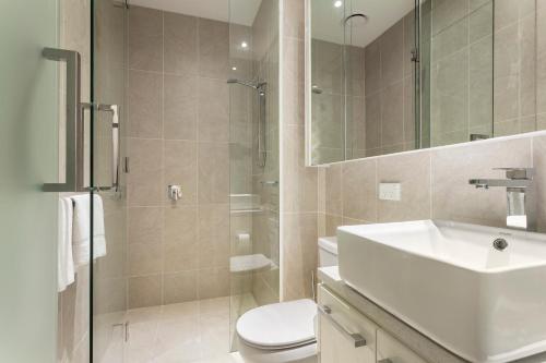 a bathroom with a sink and a toilet and a shower at Quest Frankston on the Bay in Frankston