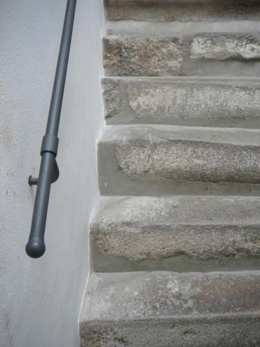 a metal pole on the side of a brick wall at Penzion-apartmán Souček in Jindrichuv Hradec