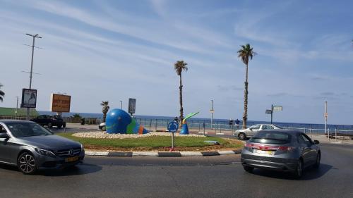 two cars parked in a parking lot near the beach at Beutifull view of batyam in Bat Yam
