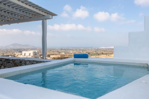 a swimming pool on the roof of a house at Seven Suites in Glinado Naxos