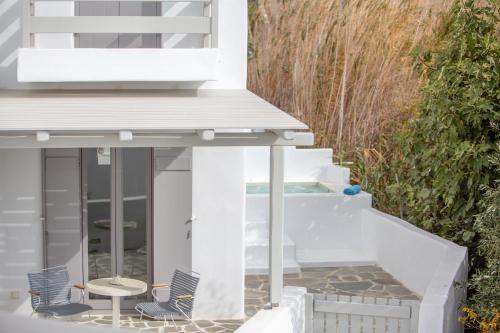 a patio with chairs and a hot tub at Seven Suites in Glinado Naxos