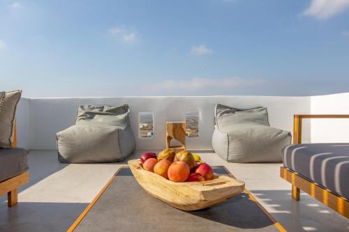 a bowl of fruit in a room with a couch at Seven Suites in Glinado Naxos