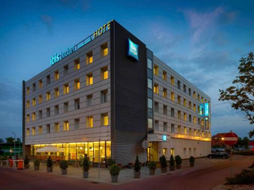 a hotel building with a sign on top of it at ibis budget Katowice Centrum in Katowice