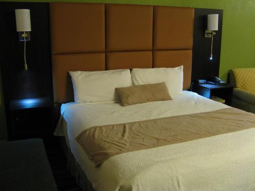 a bedroom with a large bed with a large headboard at Inn at Portland in Portland
