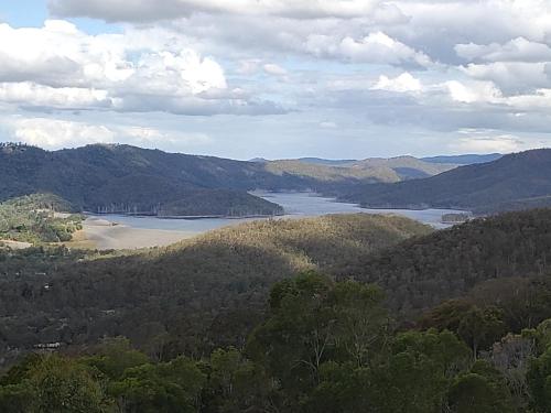 a view of a valley with a lake and mountains at Bottletree Gardens - Mini Manson Blue in Gold Coast