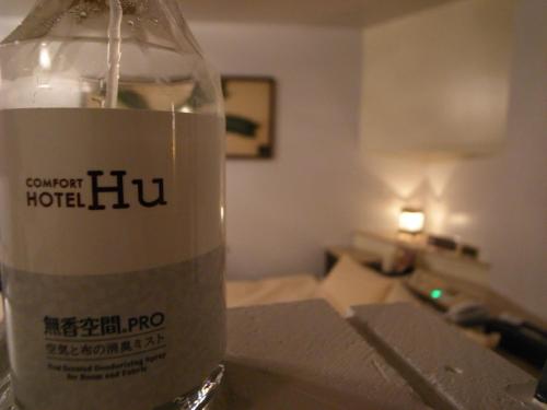 a bottle of water sitting on a table in a room at Comfort Hotel Hu in Koshigaya