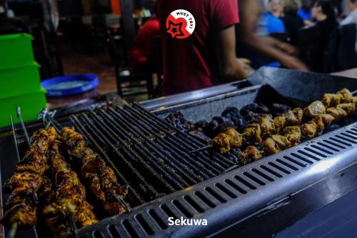 a grill with meat and other food on it at Hotel Happy Home or Mudkhu Durbar in Kathmandu
