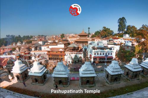 a group of buildings in a city with a sign at Shiva Shankar Hotel in Pashupatināth
