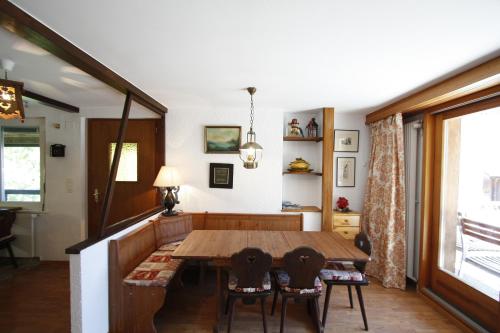 a dining room with a wooden table and chairs at Apartment Villa Franca in Crans-Montana