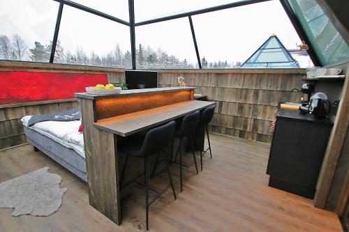 a room with a table and chairs in a house at Elves Village Hotel in Levi