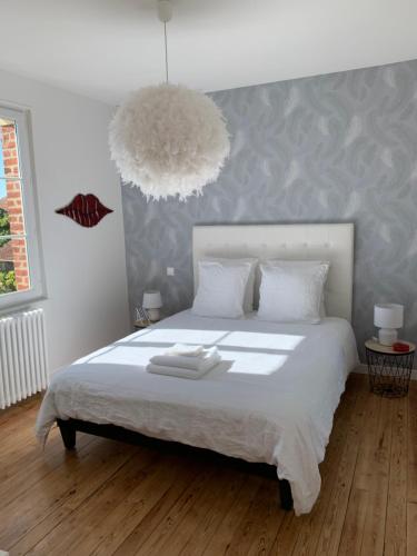 a bedroom with a large white bed with a large lamp at VILLA CATHY Chambres d hôtes in Dives-sur-Mer