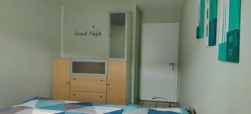 a bedroom with a bed and a dresser and a mirror at Ferienwohnung Christa in Bad Peterstal-Griesbach