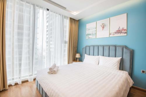 a bedroom with a bed with a teddy bear on it at Vinhomes Metropolis luxury Hotel & Residence in Hanoi