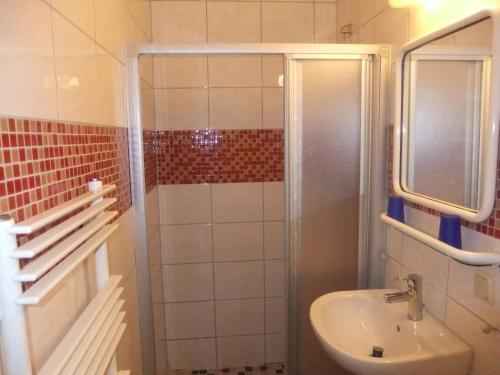 a bathroom with a shower and a sink at Hotel Adriatic in Hannover