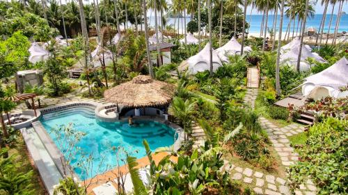 an aerial view of a resort with a swimming pool at Nacpan Beach Glamping Managed by H Hospitality Group in El Nido