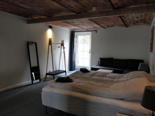 a bedroom with a large bed and a large window at B & B Gødstrup - cafe og restaurant Den Gamle Stald in Herning