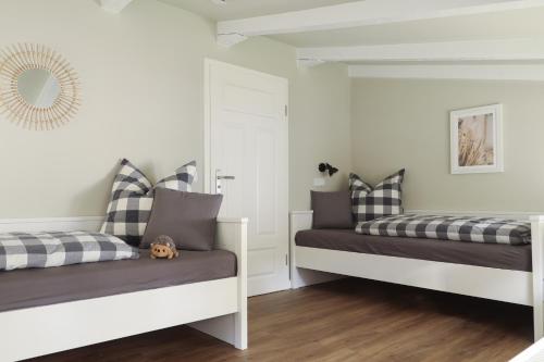 a bedroom with two beds and a mirror at Villa Oestereich in Binz
