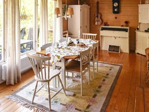 a kitchen with a table and chairs in a room at 6 person holiday home in SORUNDA in Norra Svärdsö