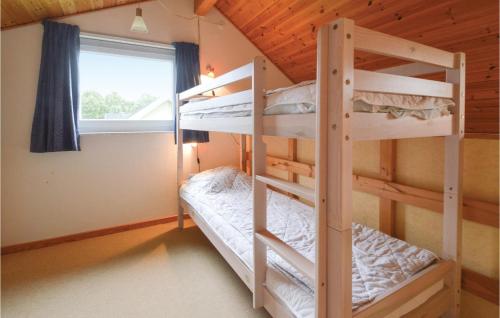 two bunk beds in a room with a window at Awesome Home In Grindsted With Kitchen in Grindsted