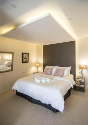 a bedroom with a large white bed with two lamps at Beo Green View in Belgrade