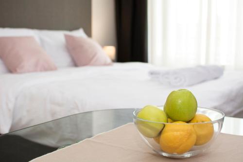 a glass bowl of fruit on a table in a bedroom at Beo Green View in Belgrade