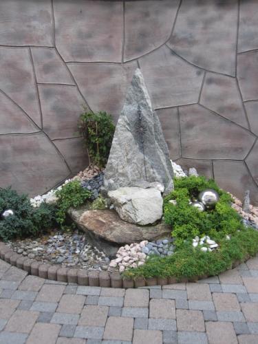 a miniature garden with a large rock and plants at Ferienwohnung Lederle Maria-Luise in Jerzens