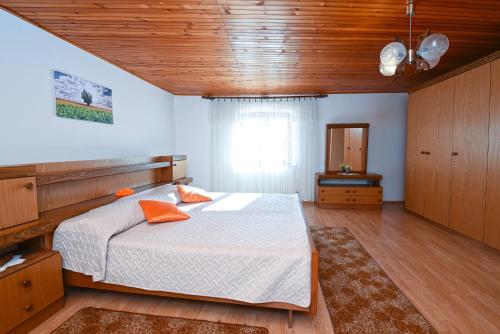 a bedroom with a large bed and a wooden ceiling at Apartment Dragica 1492 in Vodnjan