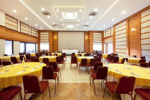 a conference room with tables and chairs and a podium at Sterling Thekkady in Thekkady